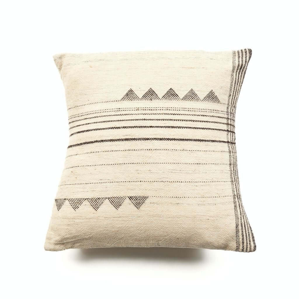 Ivory square pillow with horizontal black stripes and two rows of triangular motifs on a white background.