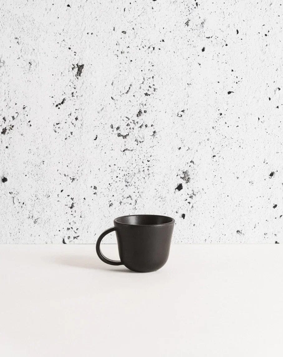 Gharyan Stoneware Japandi Tableware Mug, Matte Black, against speckled background