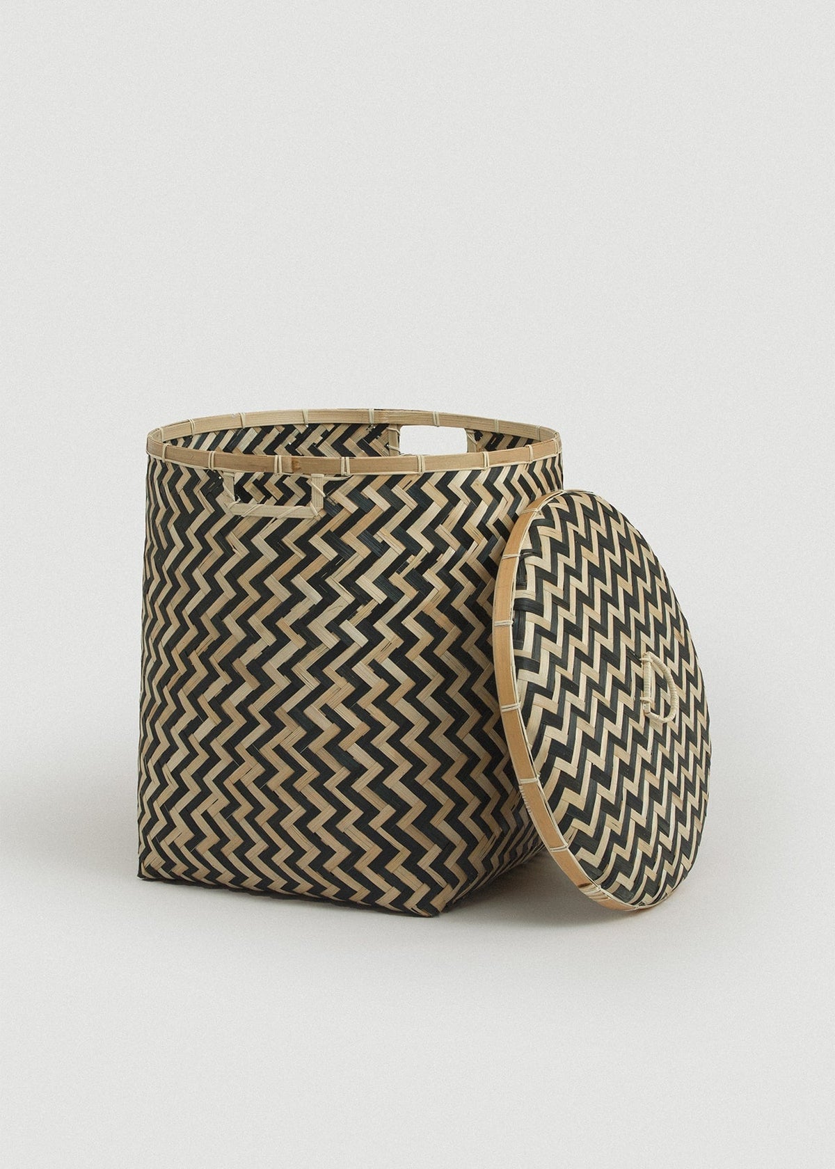 Open Java basket with the matching patterned lid leaning against its side.