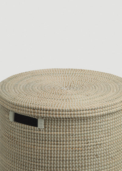 Close-up of the spiral-woven lid, thick basket rim, and contrasting black handle.