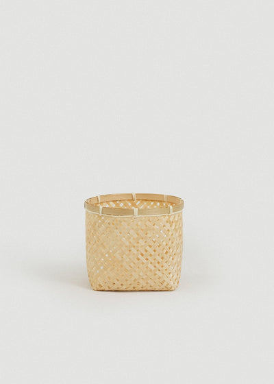 Small square bamboo basket shown alone against a light neutral background.