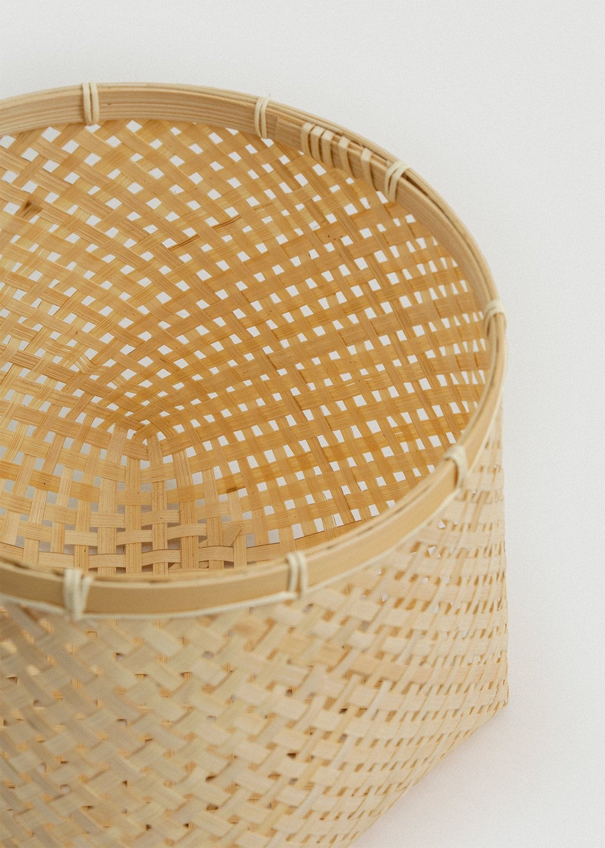 Close-up of a Muko basket showing the open woven interior, rounded corners, and reinforced rim.
