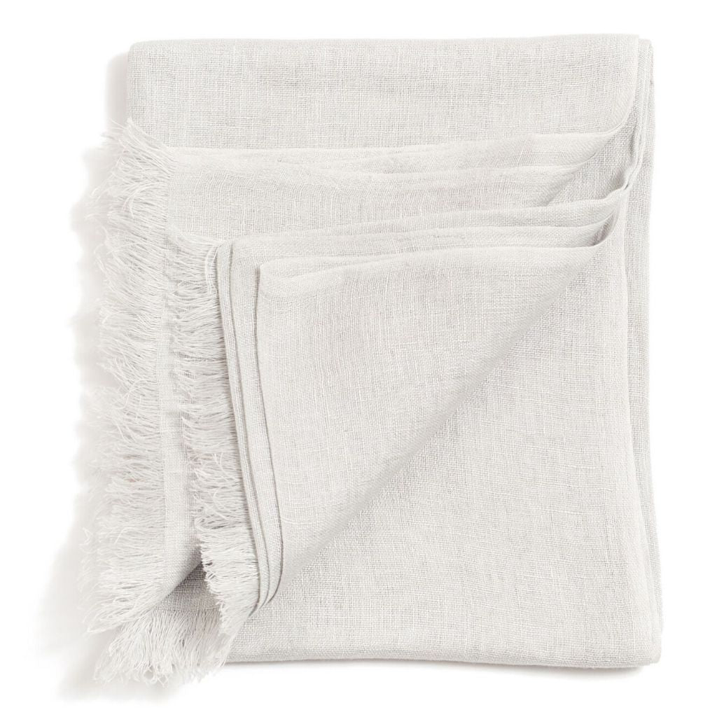 Folded white color variation of the Variously linen-silk scarf with airy texture and softly frayed edges