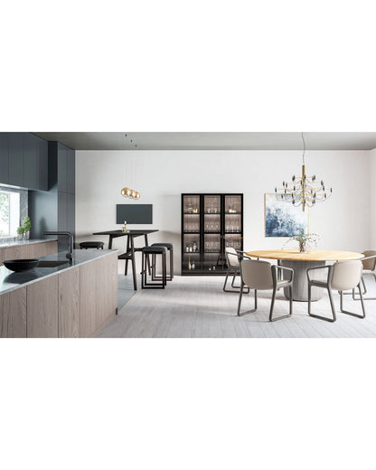 Round oak dining table in contemporary kitchen and dining space by CondeHouse