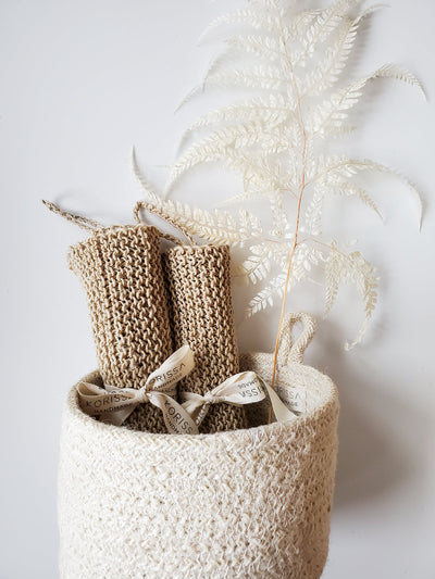 Korissa Hemp Washcloth rolled in basket with pampas grass