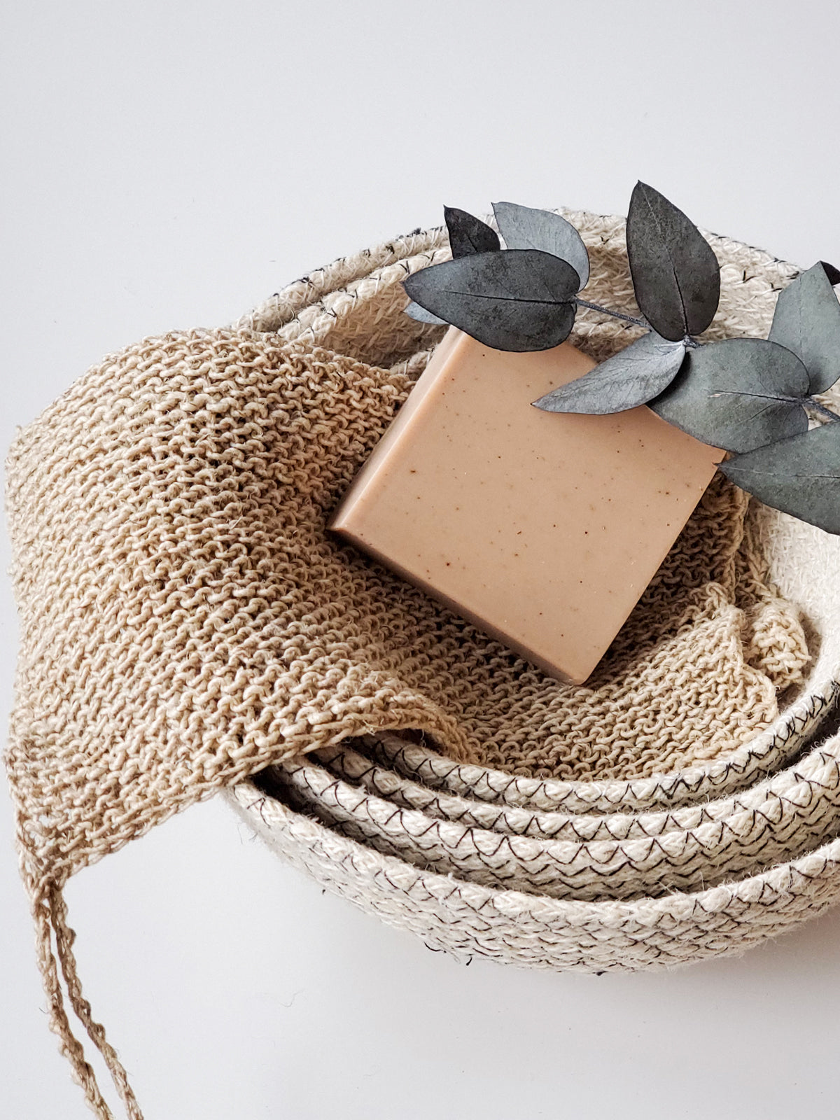 Korissa Hemp Washcloth rolled in basket with gift box, close angle