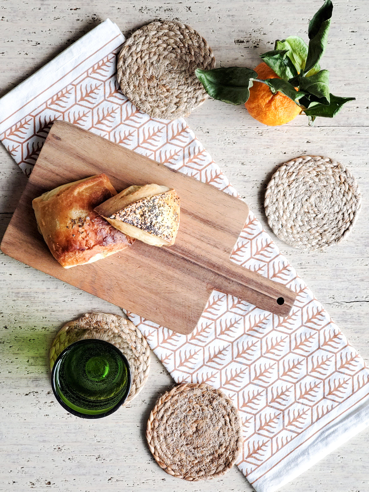 Korissa Kata Natural Drink Coaster styled with cutting board, bread, orange