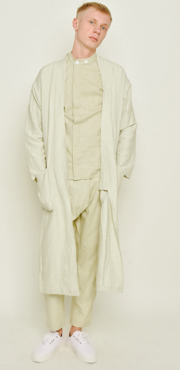 Model wearing pale cream Souk pants with layered cream clothing and white sneakers.
