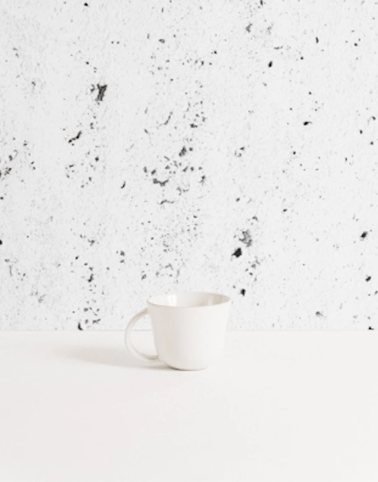 Gharyan Stoneware Japandi Tableware Mug, Matte White, against speckled background