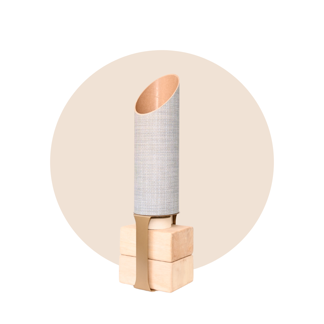 Full SeaWeave yoga mat tube and wooden block stand displayed against a pale beige circular backdrop.