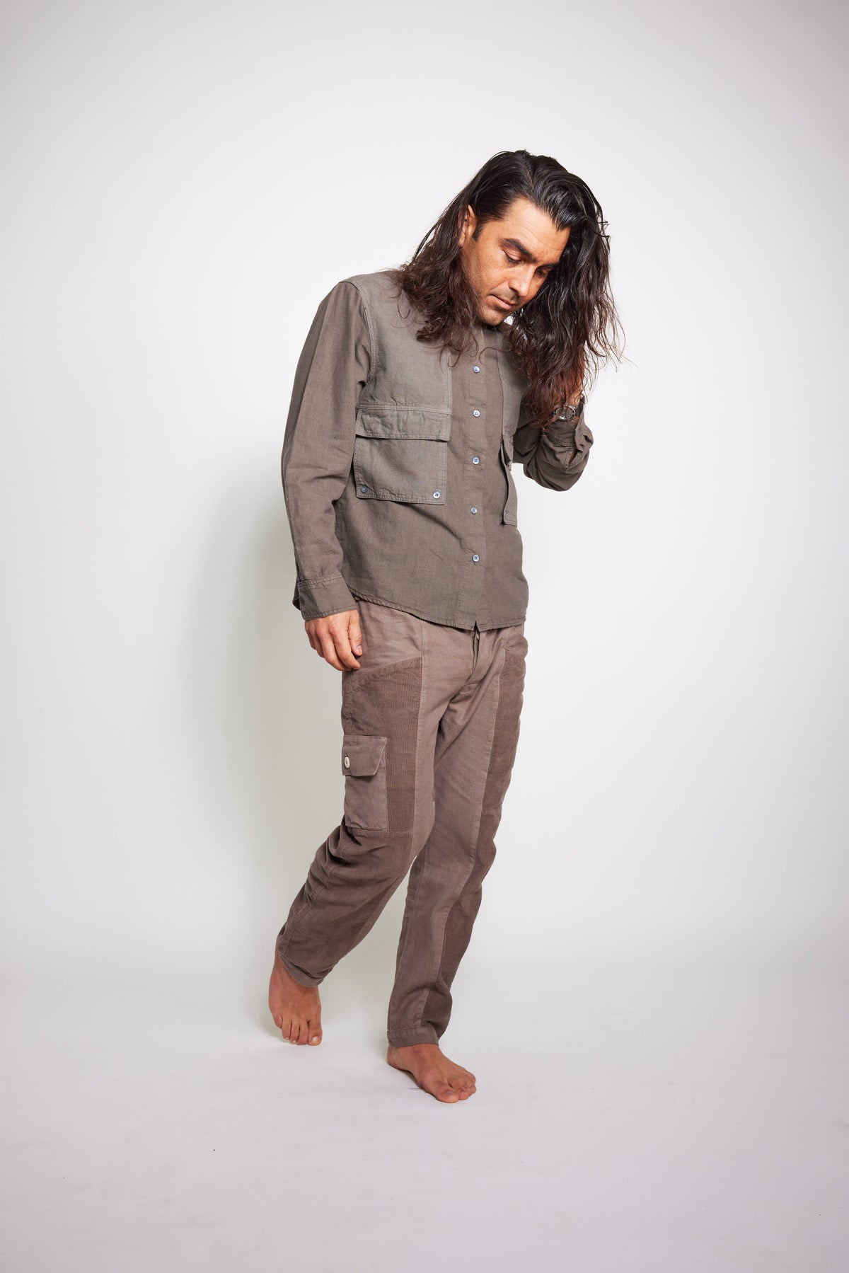 Front three-quarter view of the taupe-gray Trek Shirt worn with matching pants.