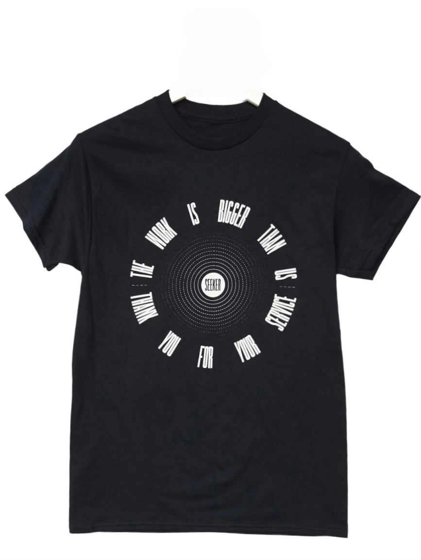 Front product view of the black Service Tee with the circular graphic printed in white.