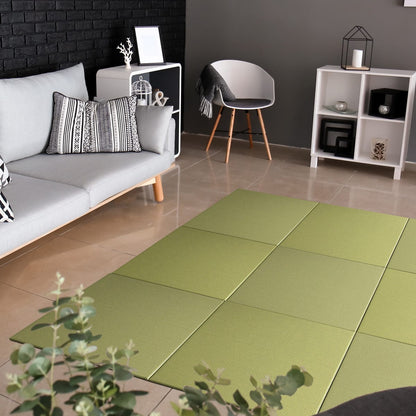 Seiryu SILVER GREEN Japandi Tatami Mat placed on the floor of a modern living room setting, surrounded by a sofa, armchairs, and decorative items.
