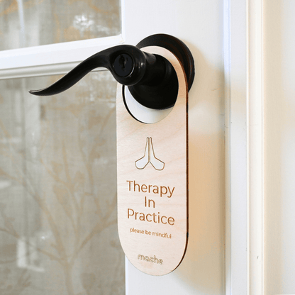 Door handle with a 'Therapy In Practice' sign on a door