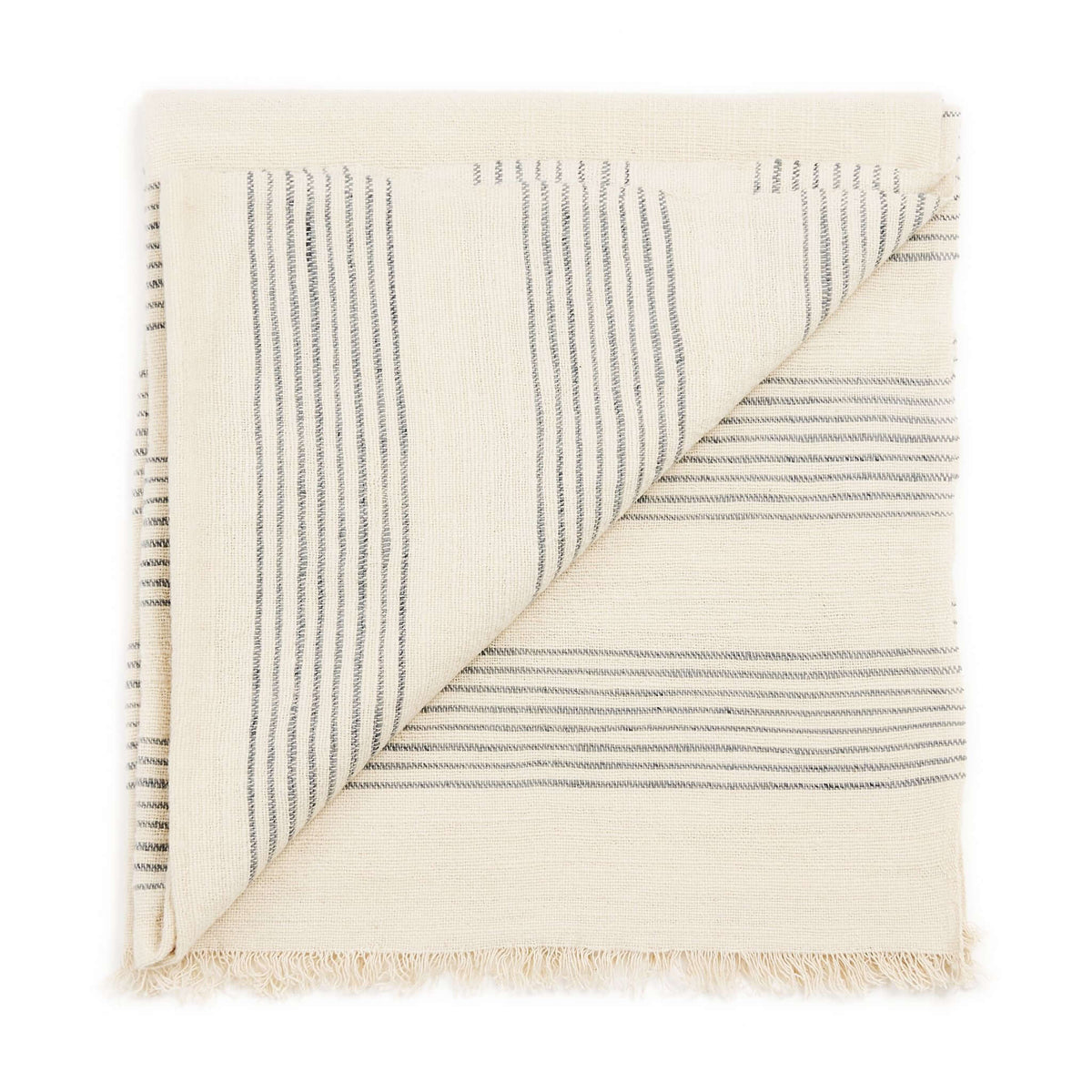Folded Silica Chalk throw with one corner turned back to reveal alternating vertical and horizontal gray stripe sections