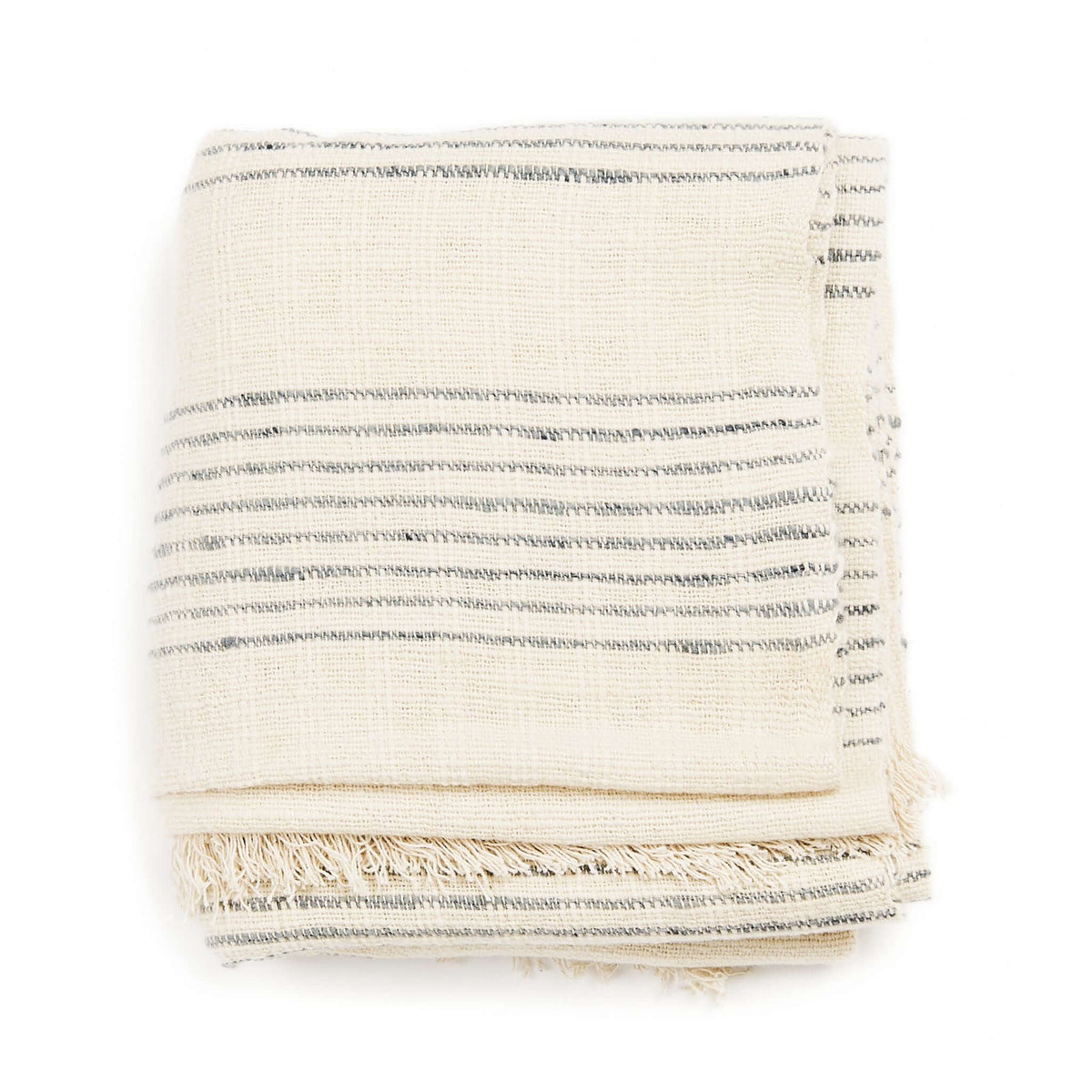 Stacked Silica Chalk handwoven throw showing its off-white texture, narrow gray lines and layered fringe