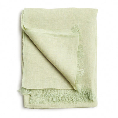 Folded pale green color variation of the Variously handwoven linen-silk scarf with a soft fringed edge