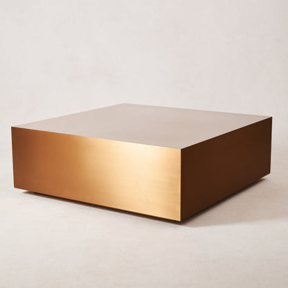 Angled view of copper coffee table showing sculptural geometry