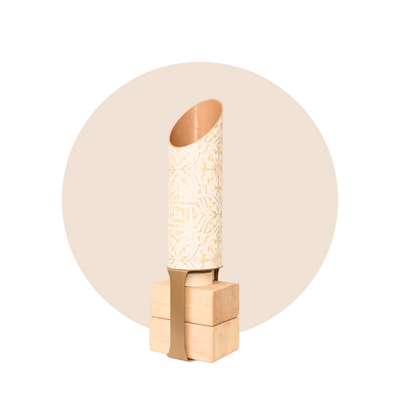 Full Star Crossed yoga mat tube and wooden block stand displayed against a beige circular backdrop.