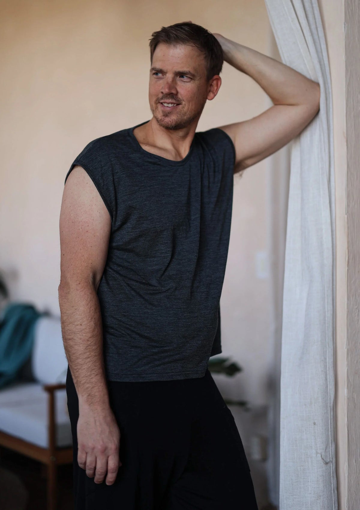 Man wearing a charcoal merino wool sauna tee designed for sauna, recovery, cold plunge, and everyday comfort.