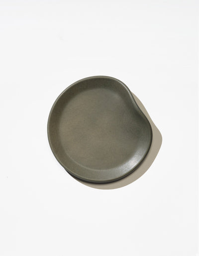 Tortuga Forma Bread Plate Single in Liche viewed overhead on white, showing its finely textured centre, gently curved rim and softly indented edge.