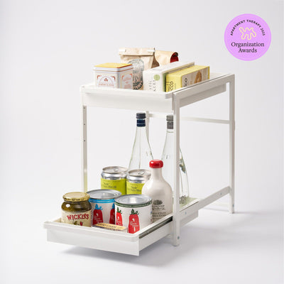 The Two-Tier Pull-Out Shelf is designed to bring order to under-sink cabinets, pantries, and utility spaces by making stored items easier to access and organize.