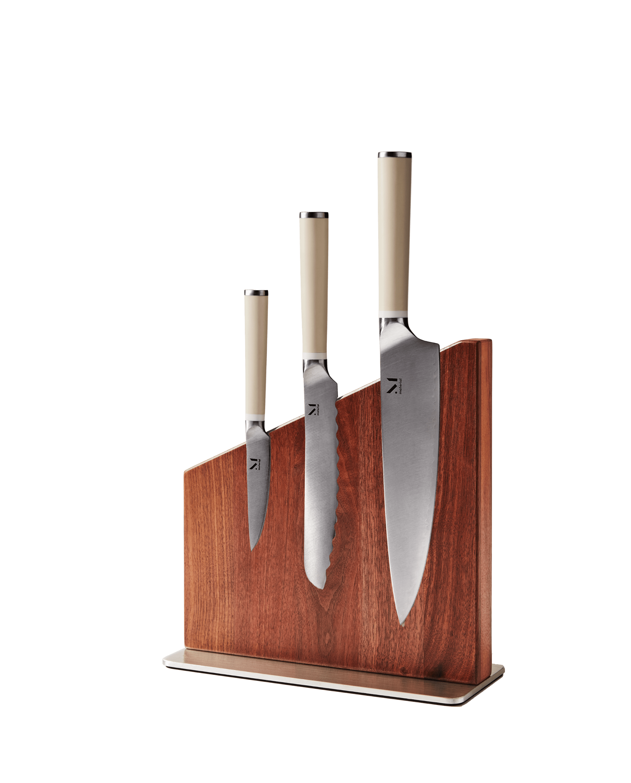 Three kitchen knives displayed in Material's magnetic wooden knife stand