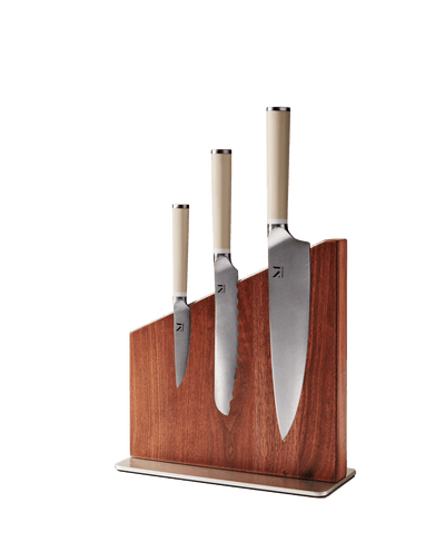 Three kitchen knives displayed in Material's magnetic wooden knife stand