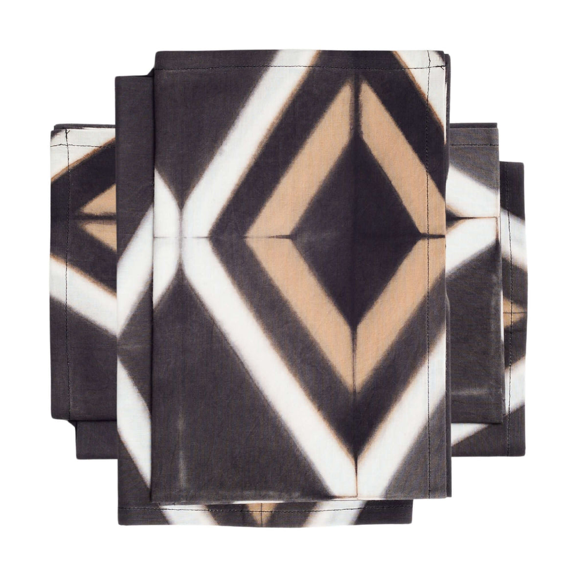 Stacked set of black shibori napkins showing the large central cream-and-tan diamond motif.