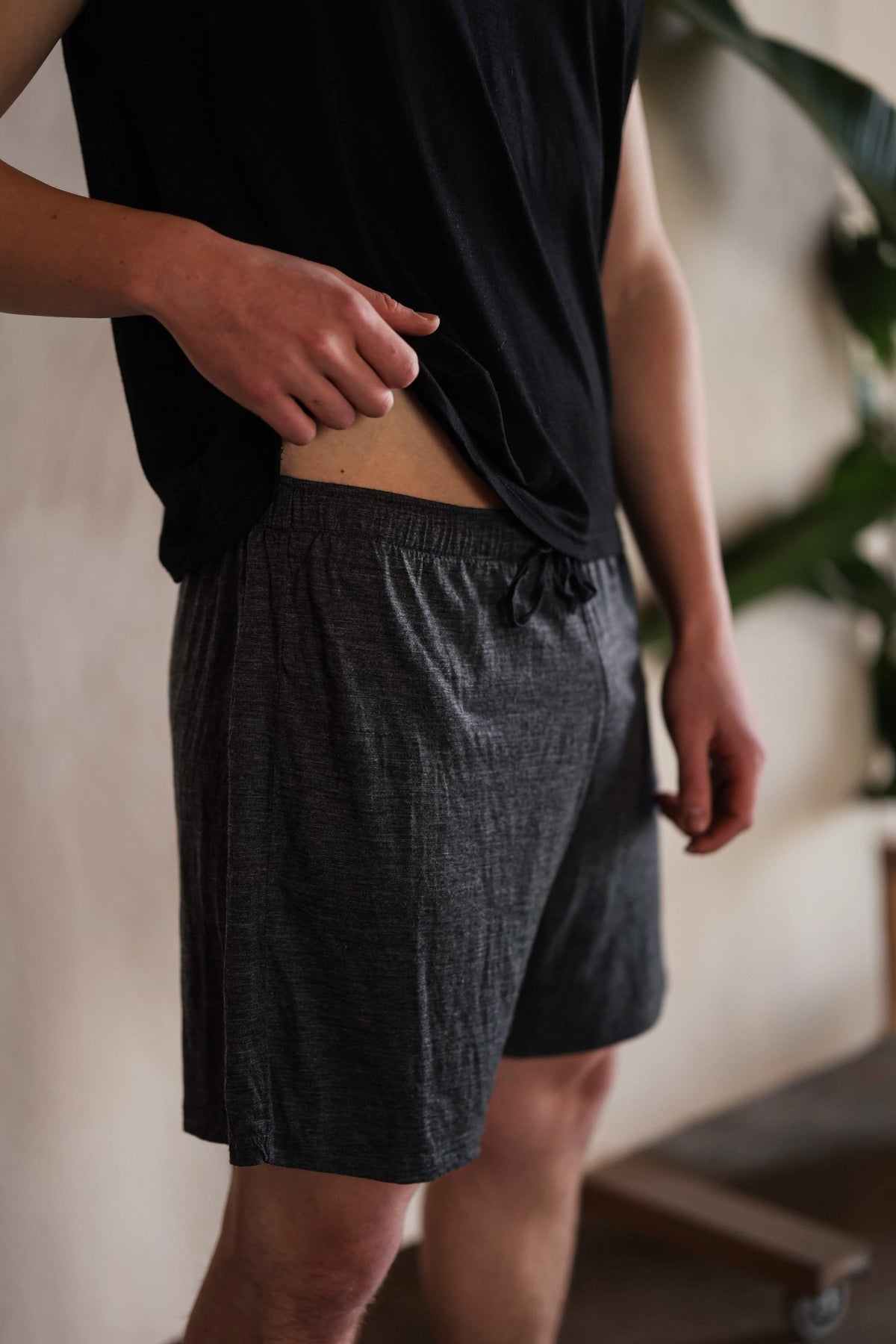 Men's merino wool sauna shorts in charcoal gray with relaxed fit and breathable natural fabric for sauna, recovery, and everyday comfort.