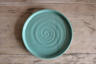 Turquoise handmade ceramic dinner plate with spiral glaze texture