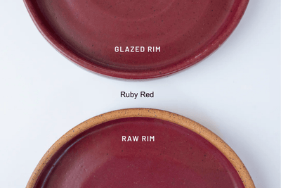 Two red ceramic plates with 'Glazed Rim' and 'Raw Rim' labels on a white background by KJ Pottery