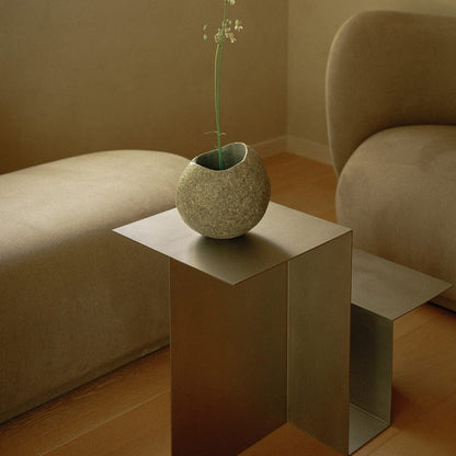 Sculptural stainless steel side table with organic curved silhouette