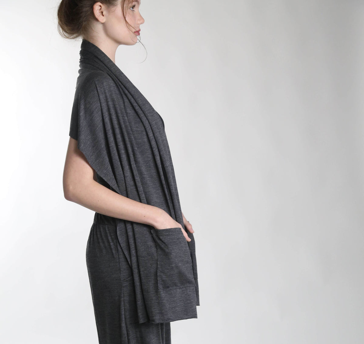 Side view of a merino wool pocket wrap showcasing its relaxed silhouette and lightweight natural wool construction.