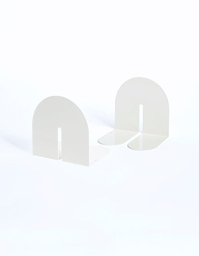 White Tortuga Forma Dumbo Bookend Pairs - The Architect Collection on a pale background, showing arched upright panels and split, rounded feet from front and angled views.