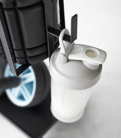 Water bottle hanging off Black Fitness Equipment Cart