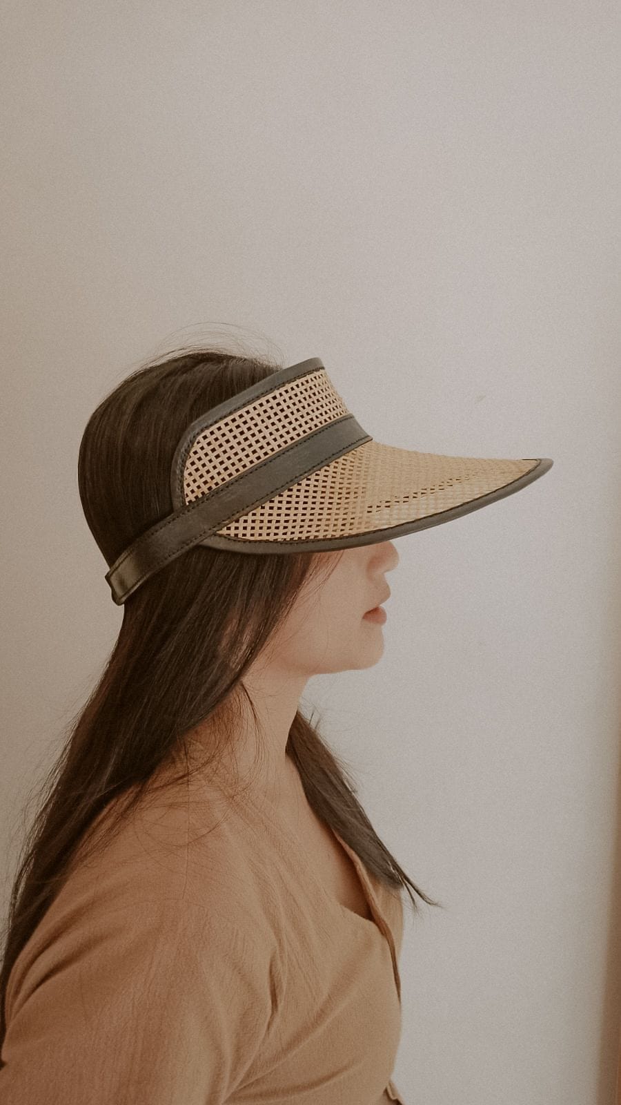 Village Thrive Sumi Leather and Cane Rattan Visor, camel rattan cane with dark leather trim, worn in profile.
