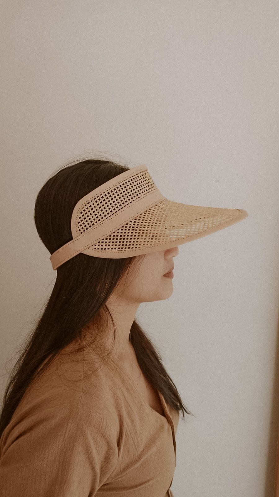 Village Thrive Sumi Leather and Cane Rattan Visor, camel rattan cane with dark leather trim, worn in profile.