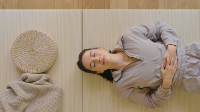 Woman laying on Japandi Tatami Mats in bedroom