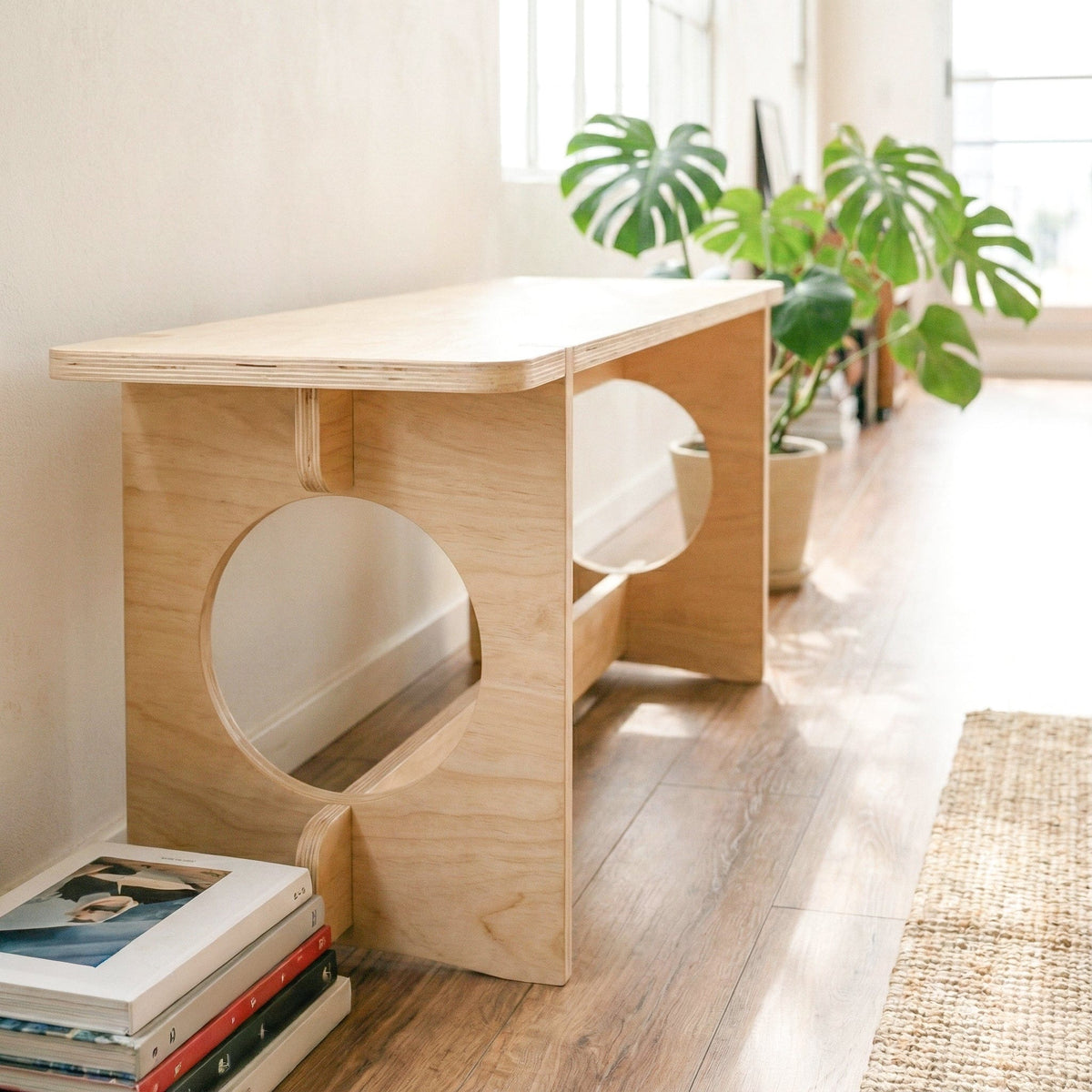 Close-up of the YOYO bench highlighting its thick wood seat, layered plywood edges, circular side openings and lower support rail