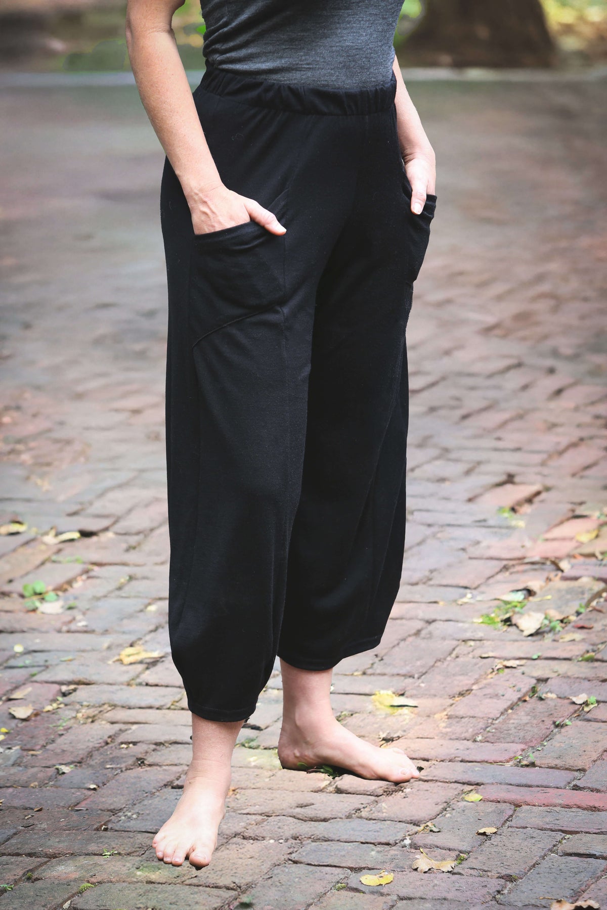 Black merino wool lounge pants featuring a fluid full-leg design, breathable warmth, and a comfortable elastic waistband.