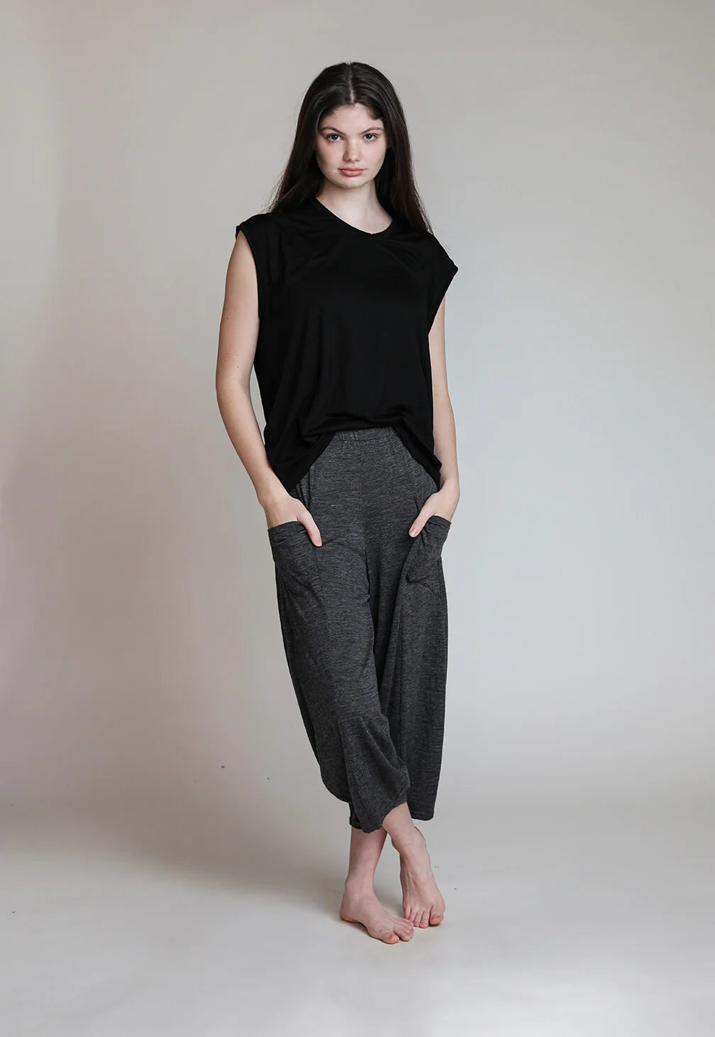 Woman wearing a relaxed-fit merino wool sauna tee and matching wool pants, showcasing natural drape and breathable comfort.