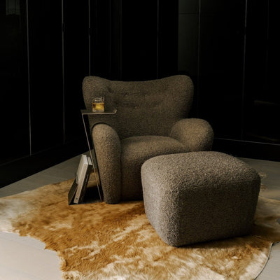 Papa Teddy Lounge Chair with matching Papa Teddy Ottoman in mocha bouclé, styled showroom setting