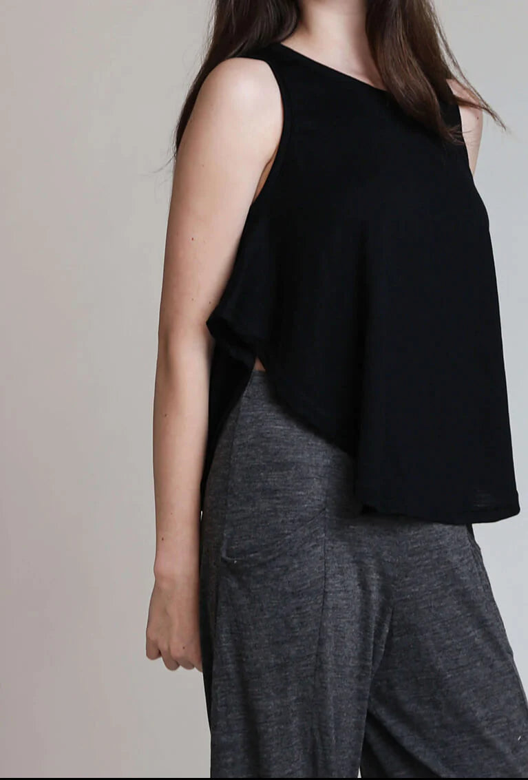 Side view of a charcoal merino wool camisole highlighting its relaxed silhouette and lightweight natural wool fabric.