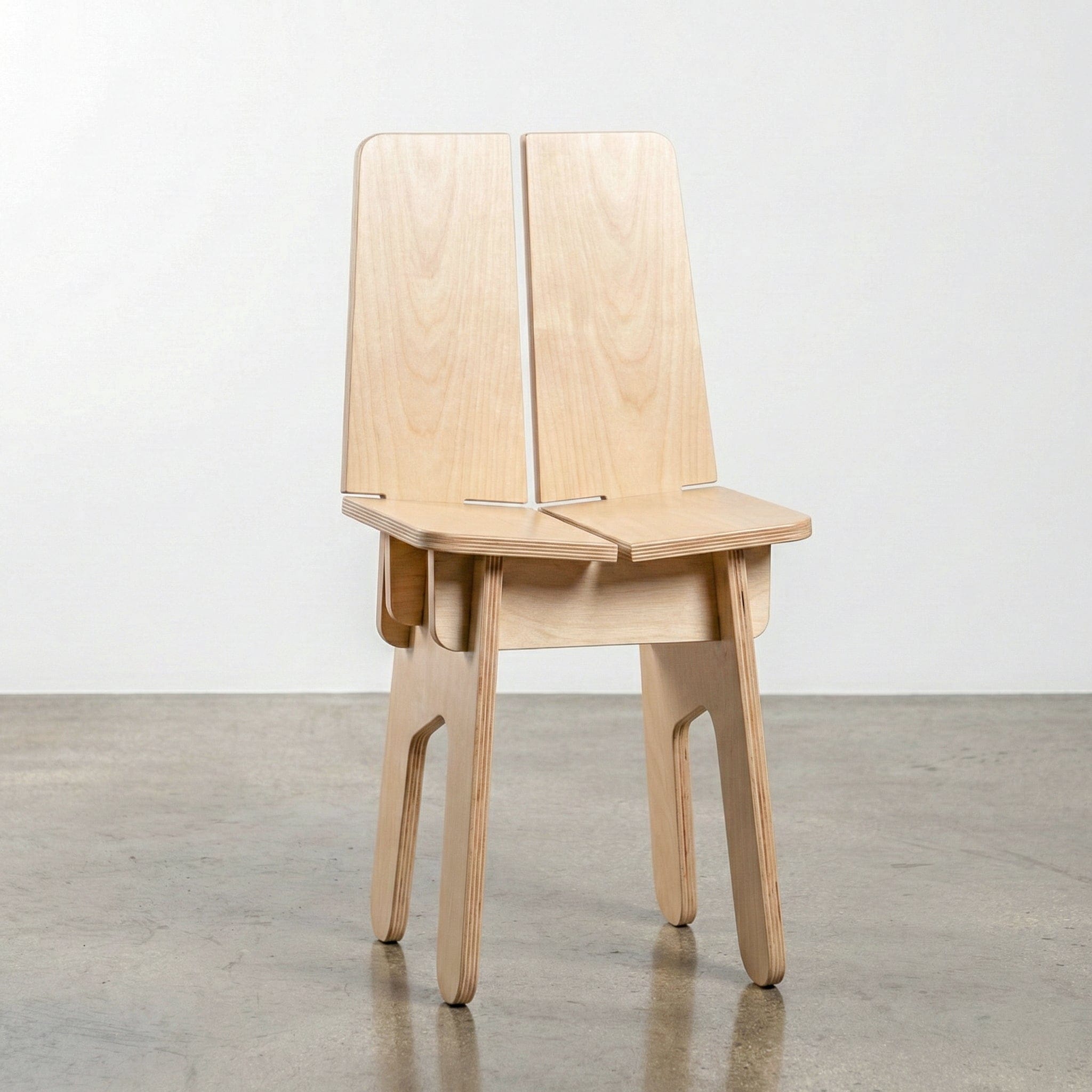 Studio Furnis BURIJ natural wood chair with a split-panel backrest, angular seat, exposed joinery and four slender legs with rounded ends