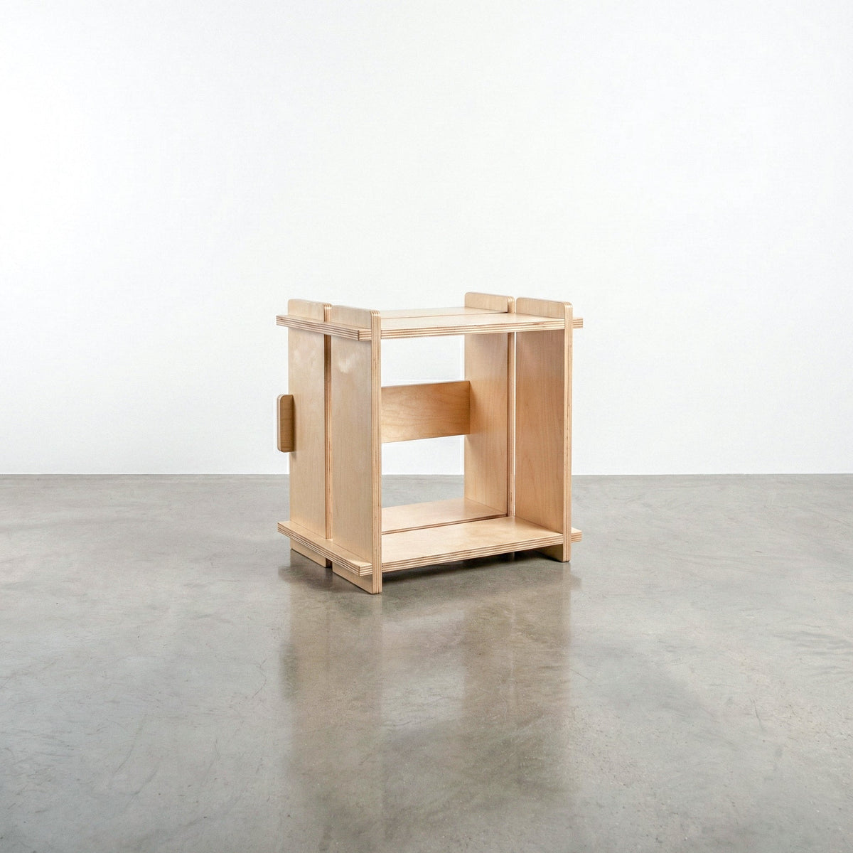 Williamsburg Cubical natural wood storage unit with an open square compartment, raised corner posts and slatted top and bottom rails on a concrete floor