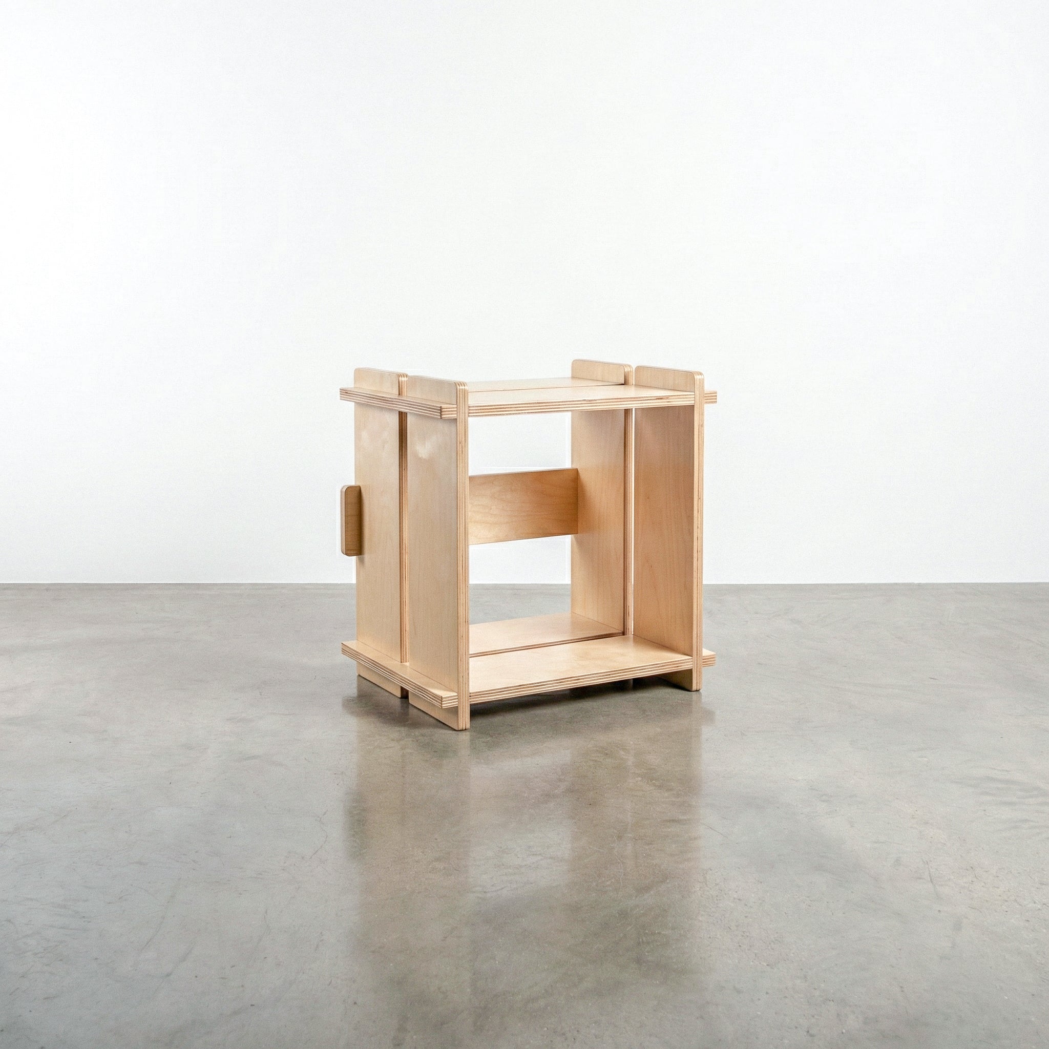 Williamsburg Cubical natural wood storage unit with an open square compartment, raised corner posts and slatted top and bottom rails on a concrete floor