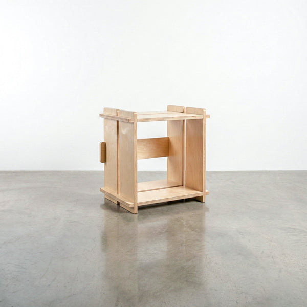 Williamsburg Cubical natural wood storage unit with an open square compartment, raised corner posts and slatted top and bottom rails on a concrete floor