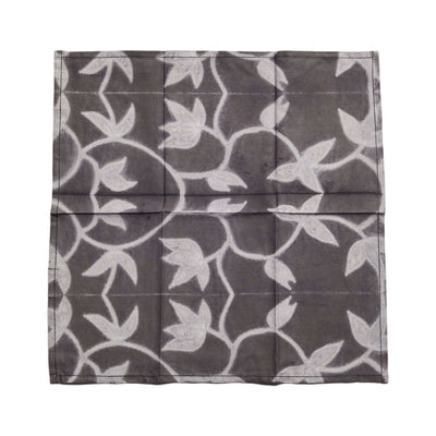 Four Folio Black handcrafted cotton napkins folded into a square stack against a white background