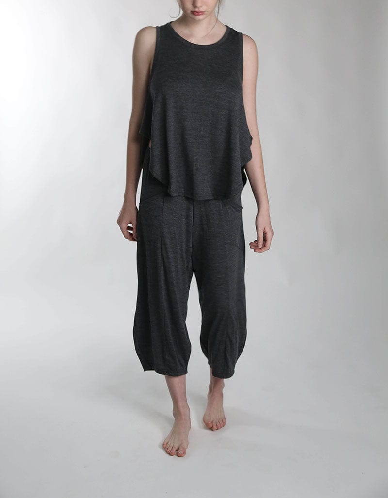 Full-length view of a woman wearing a merino wool sauna cami and lounge pants, combining comfort, breathability, and minimalist style.